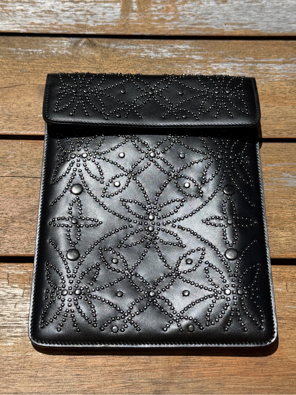 ALAÏA studded leather clutch